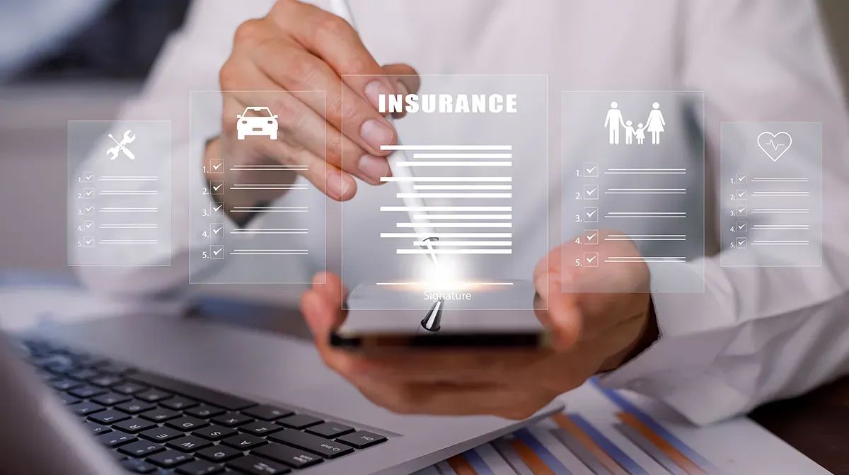 Person filling out an insurance claim form on a tablet